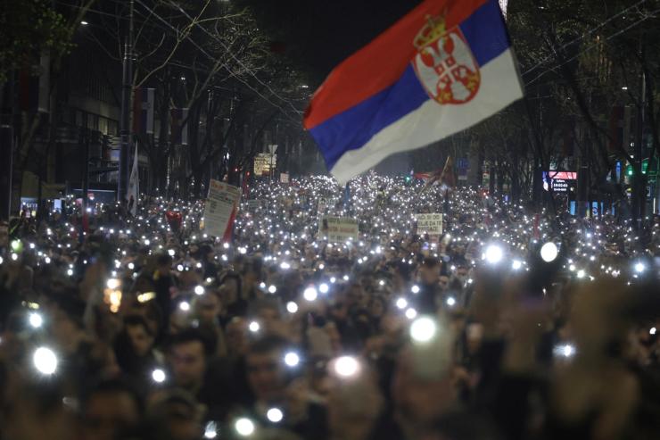 Students and anti-government demonstrators hold fifteen minutes of silence, with the flashlights of their mobile phones on, for the victims of the deadly November 2024 Novi Sad railway station roof collapse.