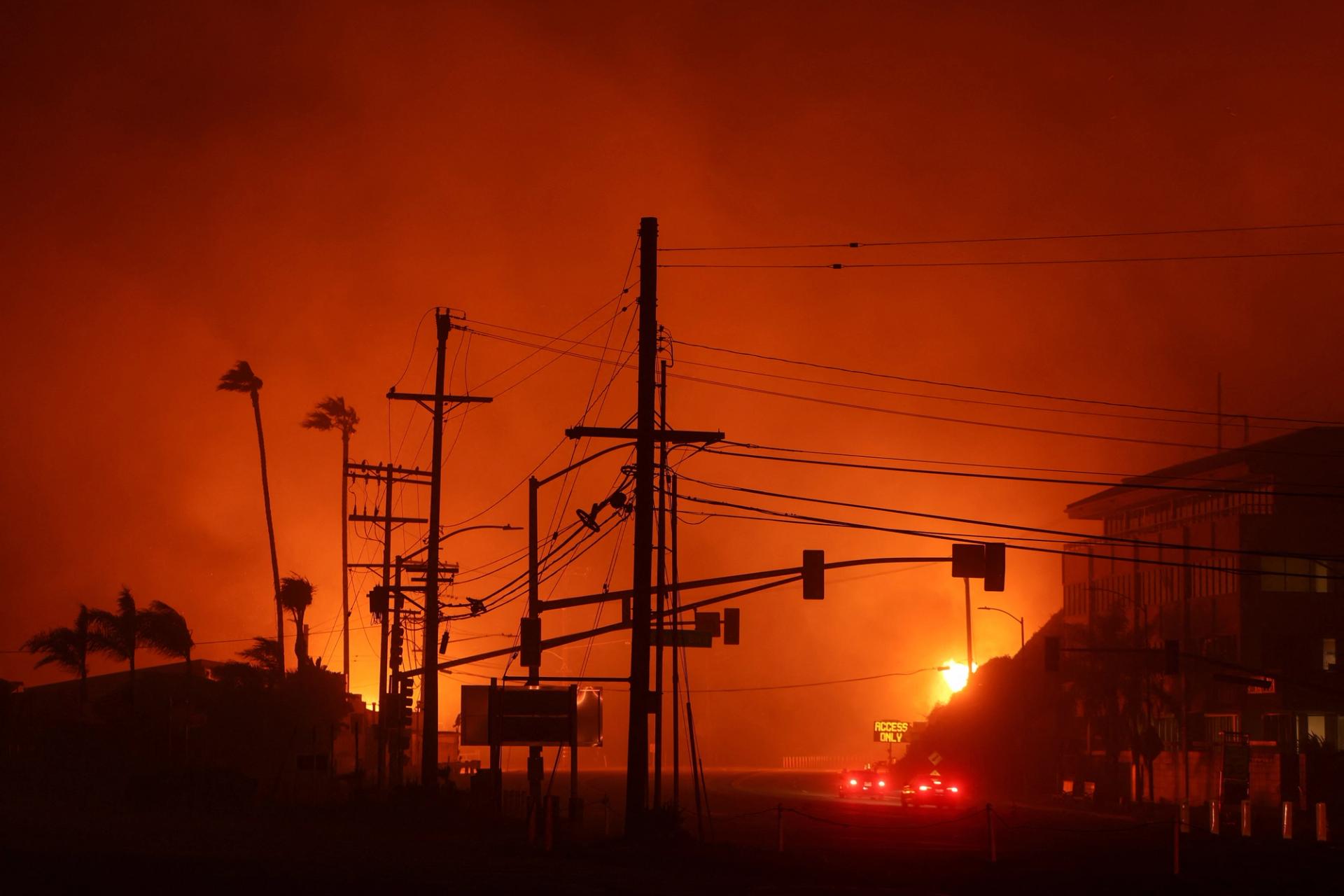 Vehicles drive along the Pacific Coast Highway, as a wildfire burns in the Pacific Palisades neighborhood of west Los Angeles, California, US.