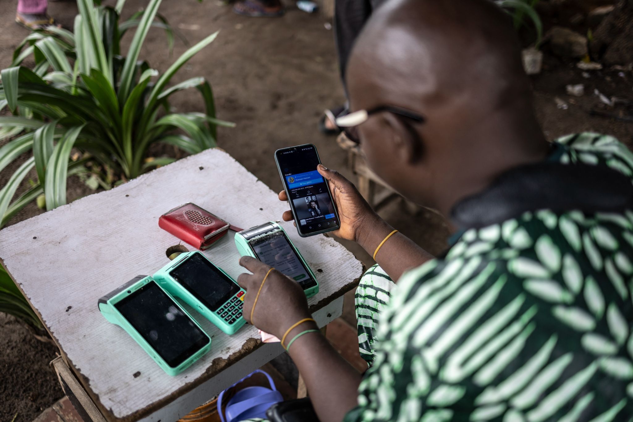 A worker works on his wireless cash machine in Ikoyi Island in Lagos.