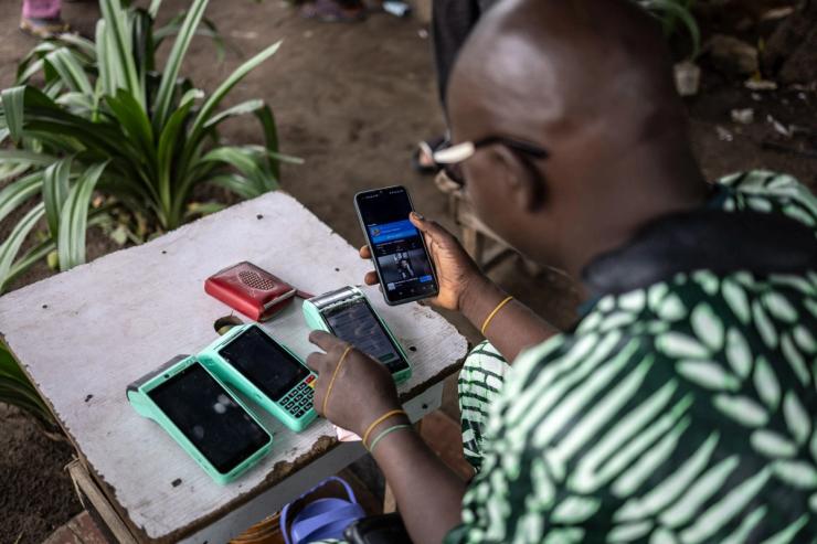 A worker works on his wireless cash machine in Ikoyi Island in Lagos.