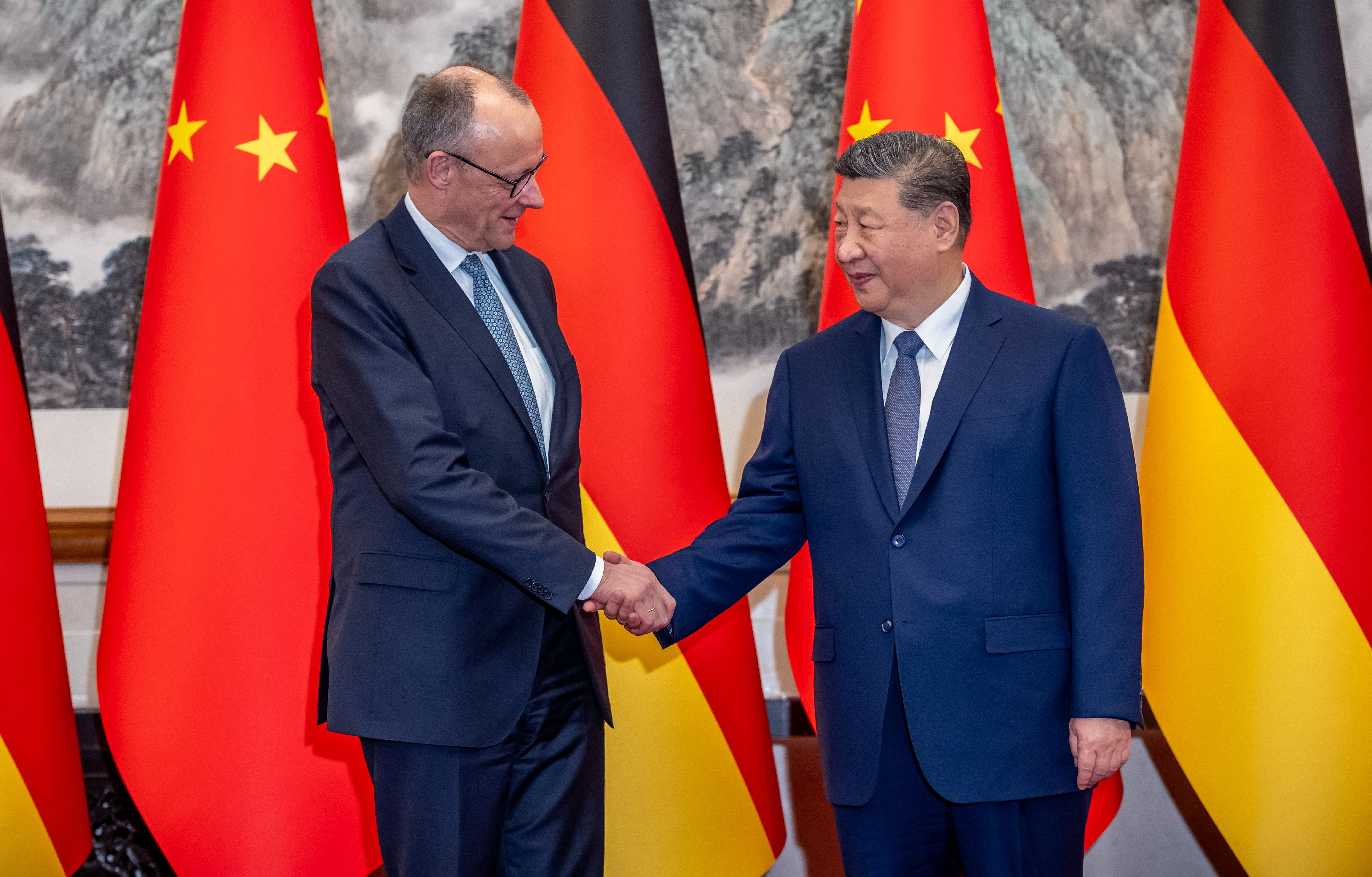 German Chancellor Friedrich Merz shakes hands with Chinese leader Xi Jinping. 