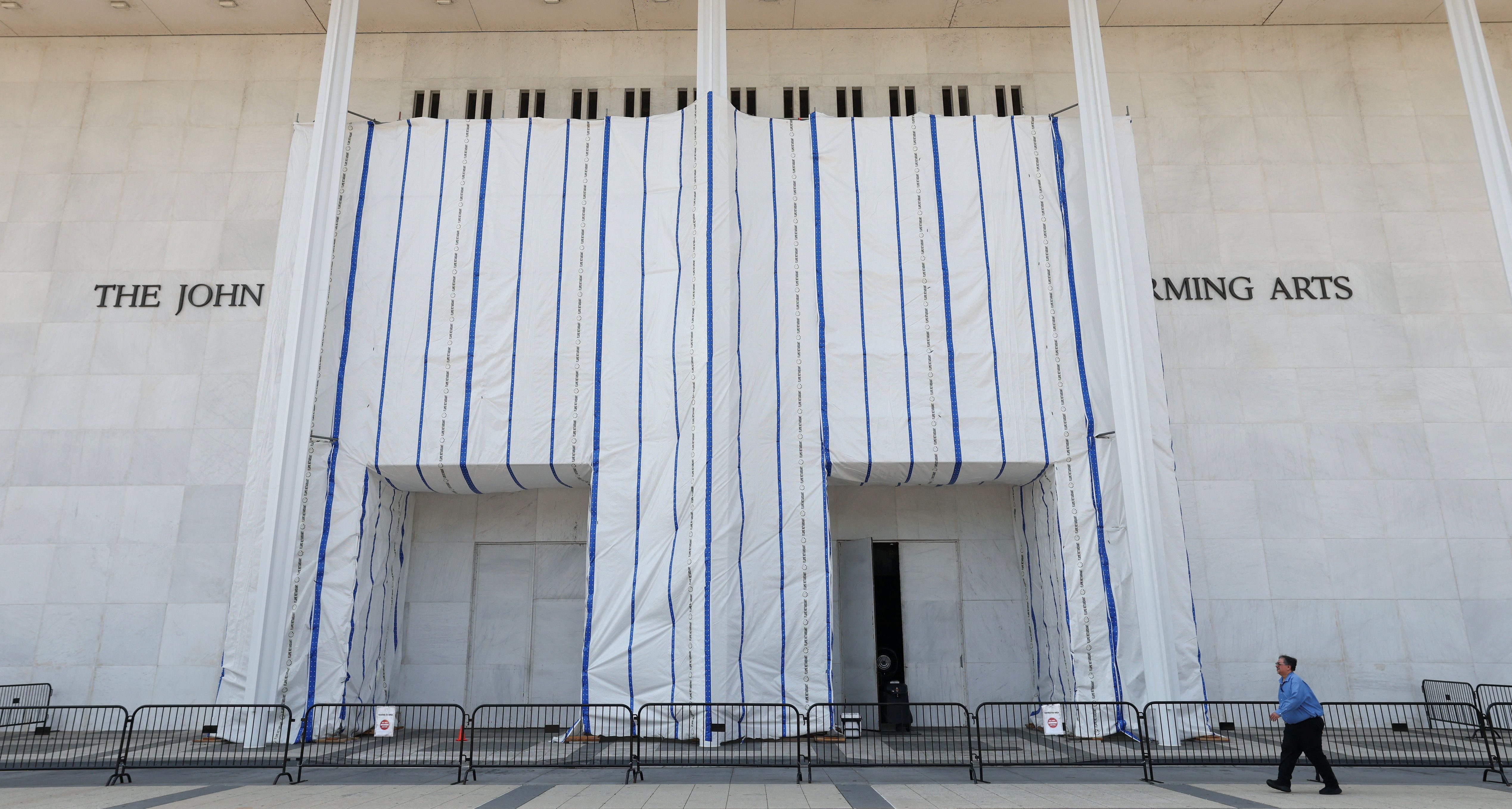 A man walks past the John F. Kennedy Center for the Performing Arts