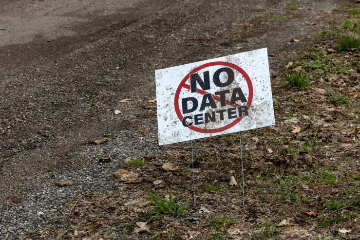 A sign that reads “No data center” sits outside a home