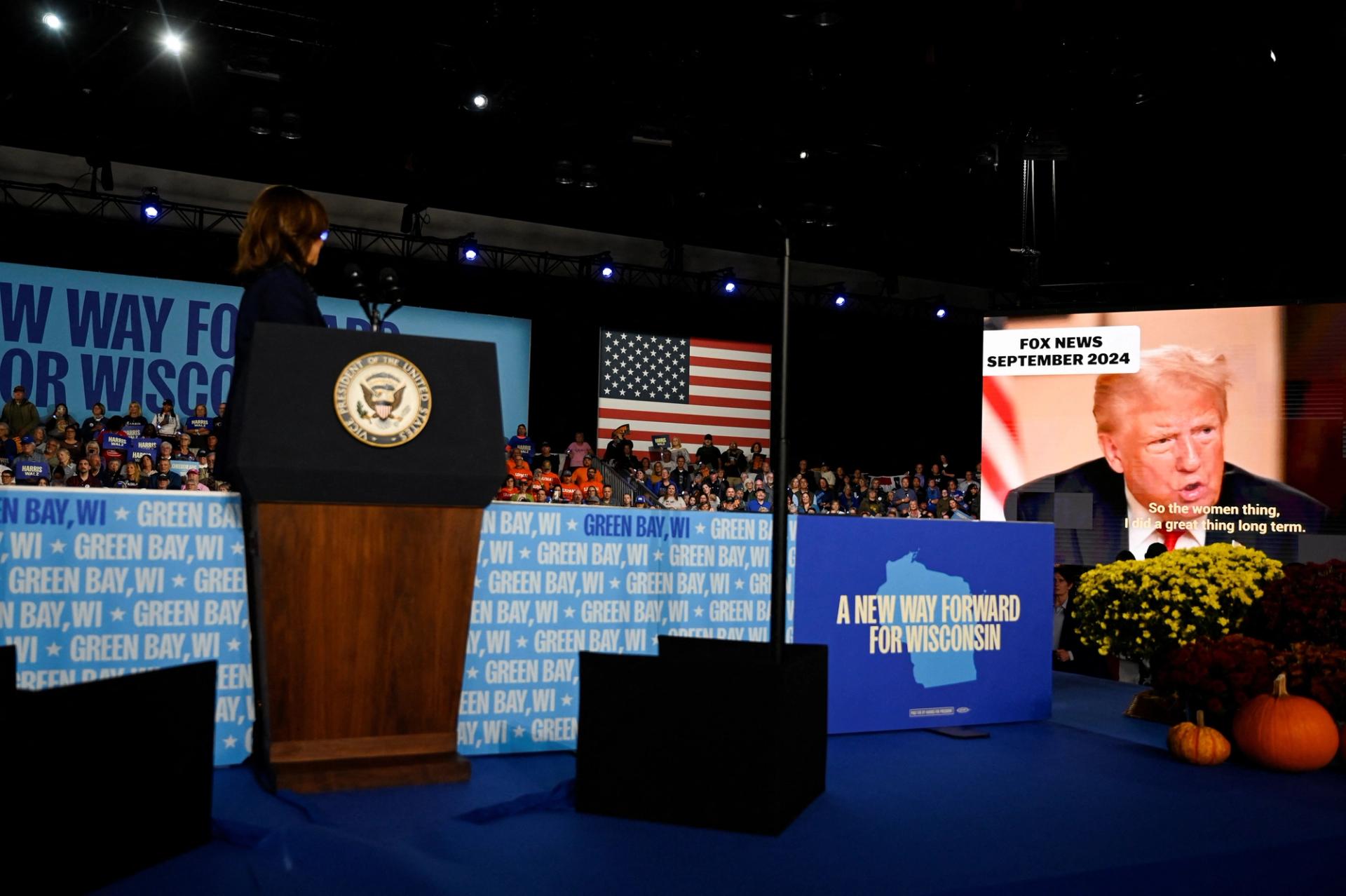 Democratic presidential nominee U.S. Vice President Kamala Harris watches a video on the screen of rival Republican presidential nominee and former U.S. President Donald Trump