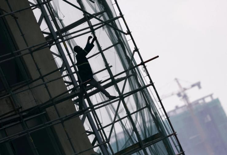 A construction worker on a scaffolding inside a high-rise building under construction in Lagos on April 29, 2025.