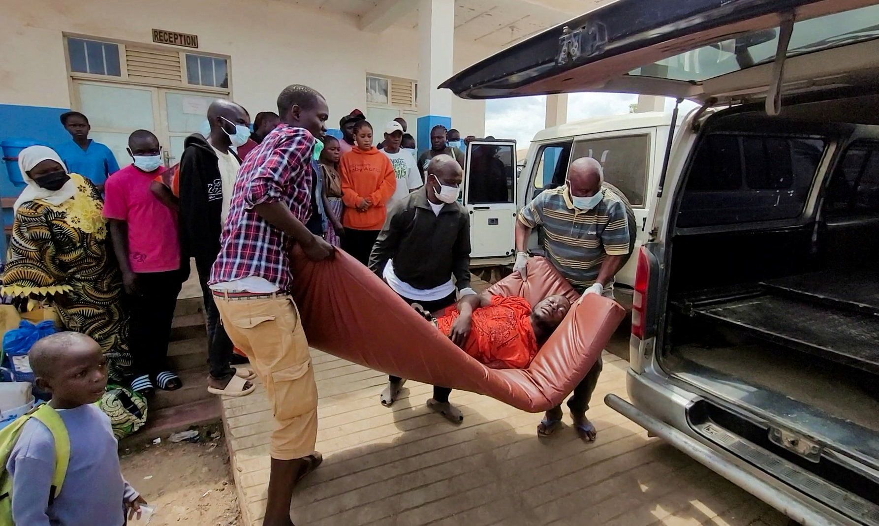 A man is carried from an ambulance as he arrives at Bunia General Referral Hospital following confirmation of an Ebola outbreak