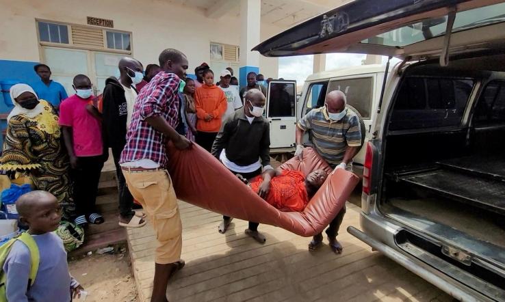 A man is carried from an ambulance as he arrives at Bunia General Referral Hospital following confirmation of an Ebola outbreak