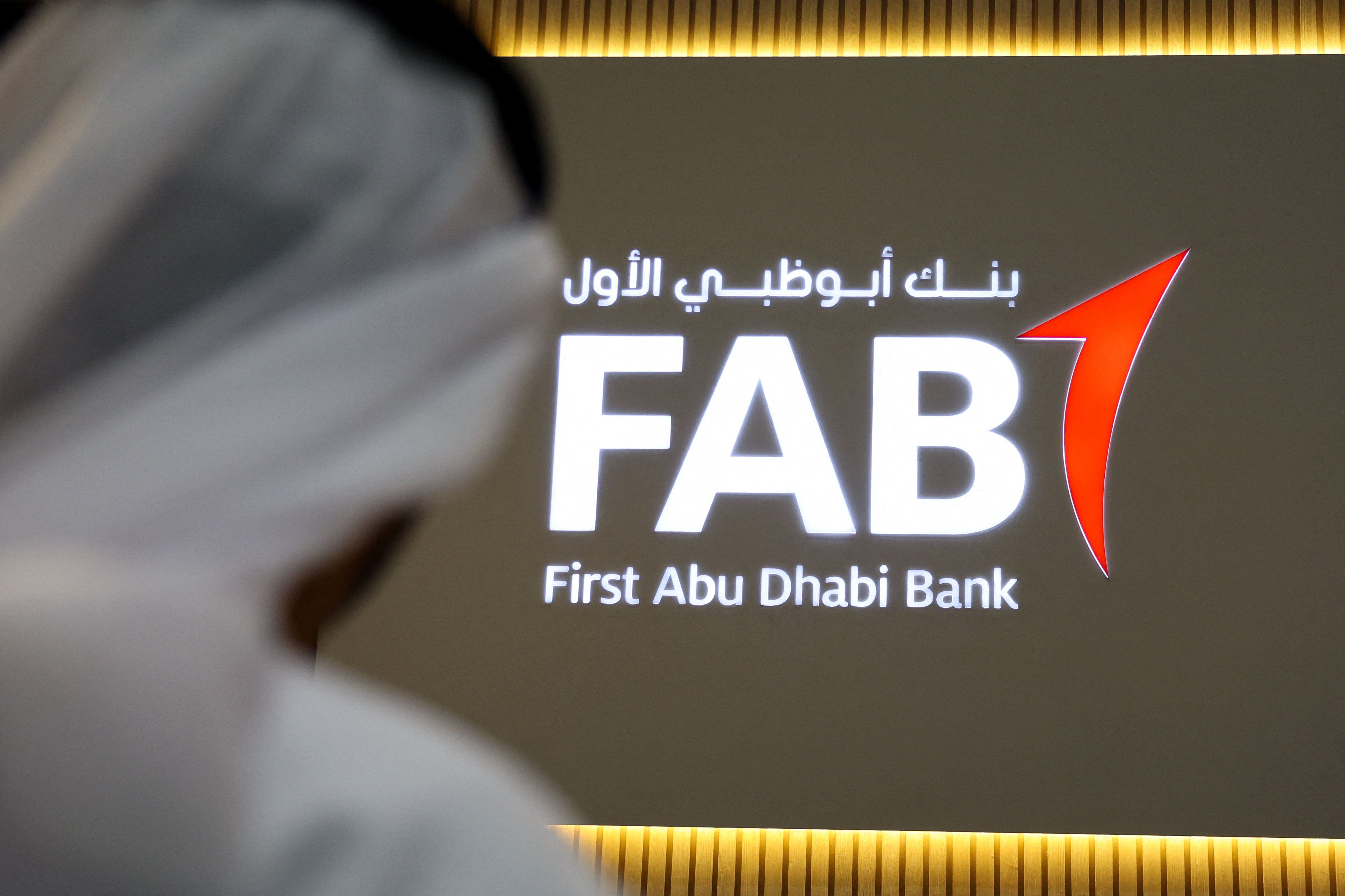 A logo of First Abu Dhabi Bank (FAB) is displayed at the Make it in the Emirates (MIITE) conference, in Abu Dhabi.
