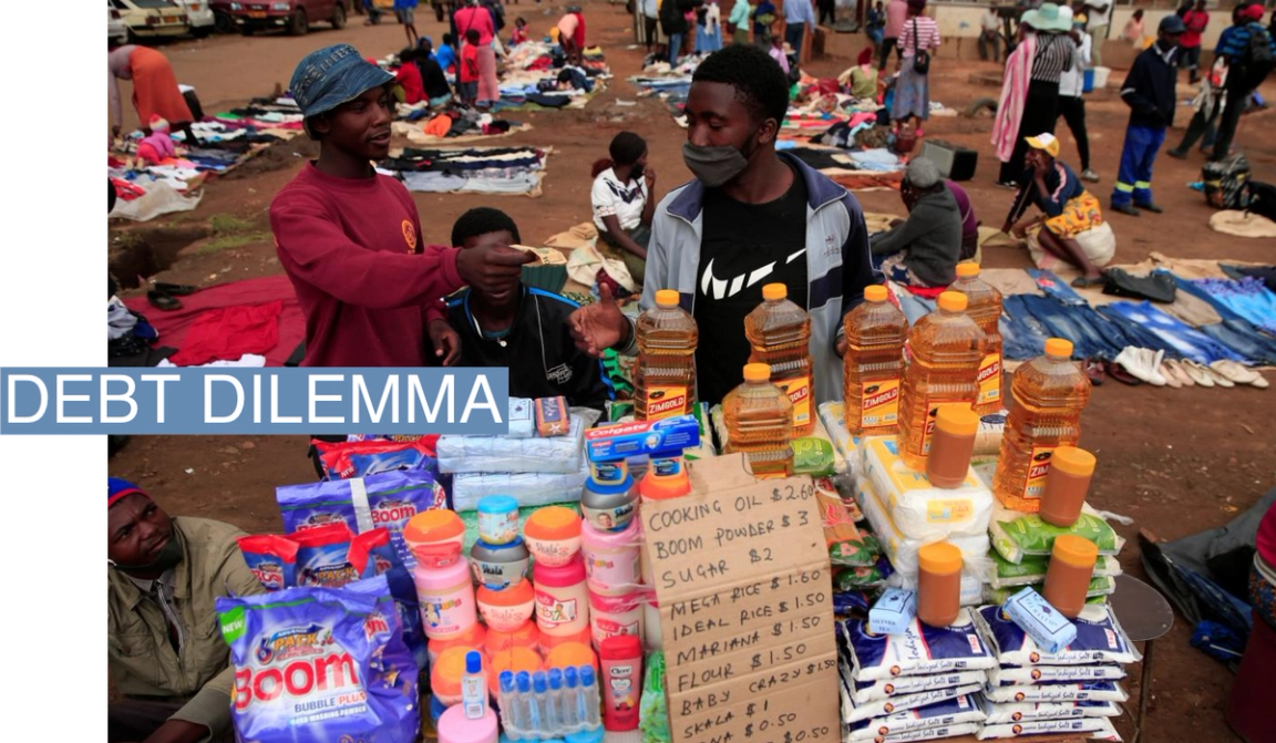 A man buys cooking oil at a market in Harare, Zimbabwe.