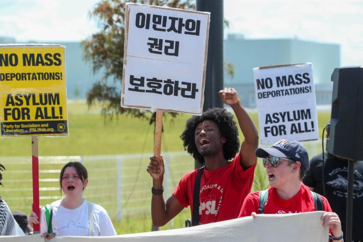Protestors hold signs and chant during a protest against ICE outside the Hyundai Metaplant on Saturday, September 6, 2025 in Ellabell Ga.
