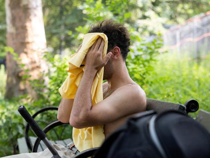A man wipes his face amid a heatwave at Brower Skate Park in New York City