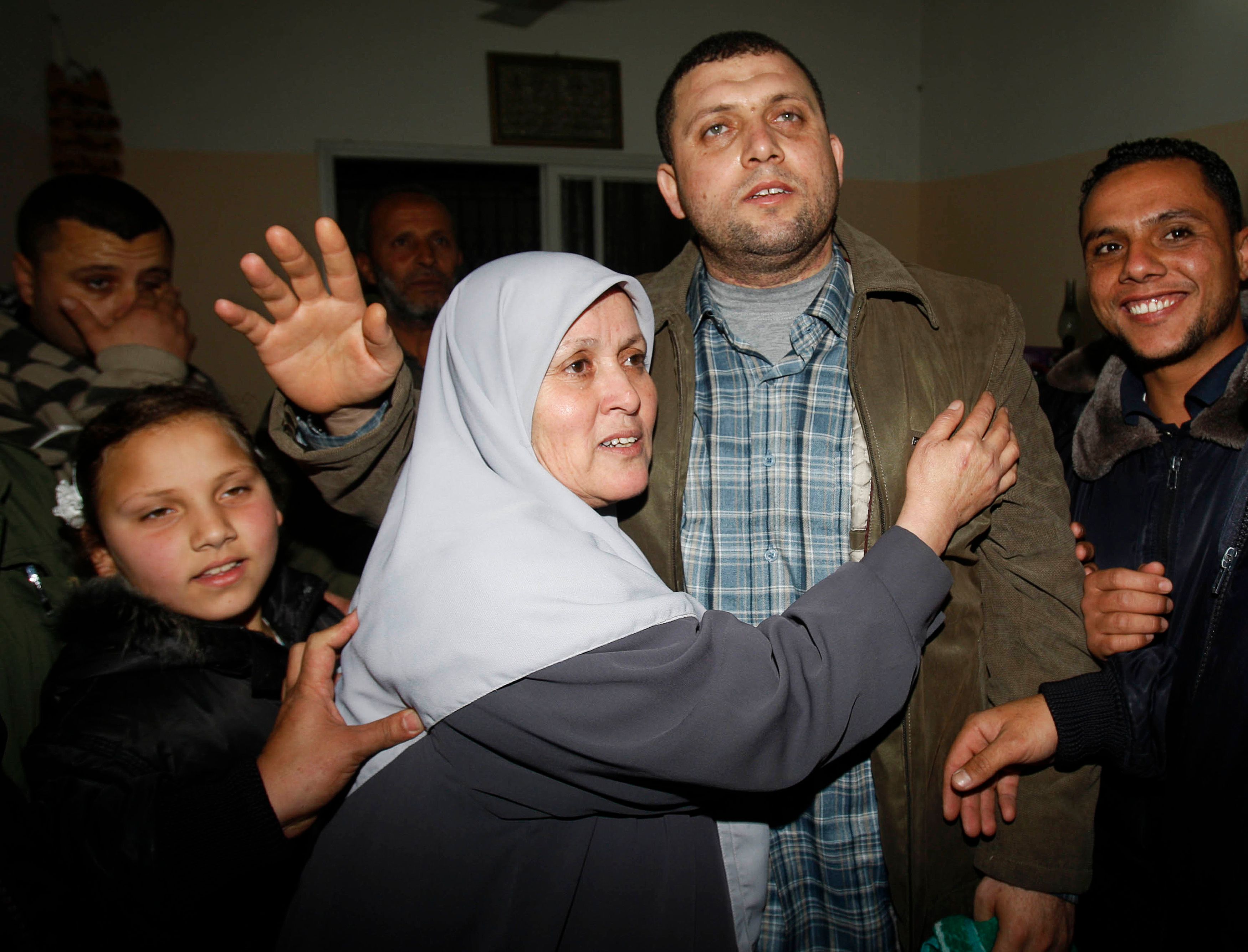 Ayman Nofal (2nd R), a top Hamas armed commander, is greeted by his relatives upon his arrival to his home in Nusairat in the Central Gaza strip February 5, 2011. A senior Hamas commander returned to the Gaza Strip on Saturday after breaking out of a Cairo jail during the political upheaval in Egypt, sources in the Palestinian Islamist movement said. They said Ayman Nofal had been arrested in the Egyptian Sinai in early 2008. According to Egyptian media, he had been armed and was suspected of hunting members of the rival Palestinian faction Fatah who had fled from neighbouring Gaza. REUTERS/Ibraheem Abu Mustafa