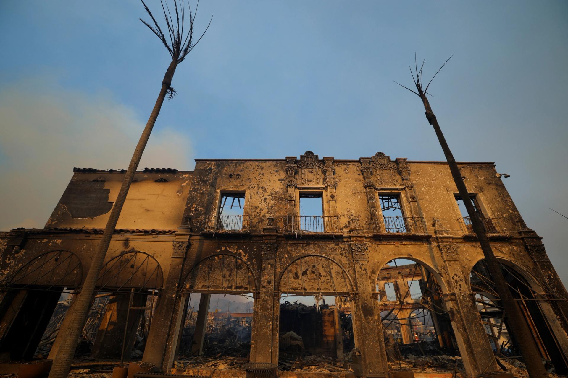 The remains of a burnt building are pictured as powerful winds fueling devastating wildfires in the Los Angeles area force people to evacuate, in the Pacific Palisades neighborhood of west Los Angeles, California.