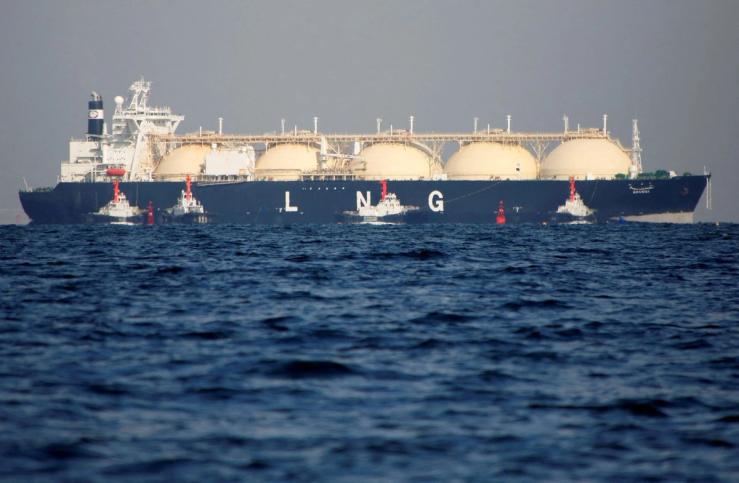 A LNG tanker is tugged towards a thermal power station in Futtsu.