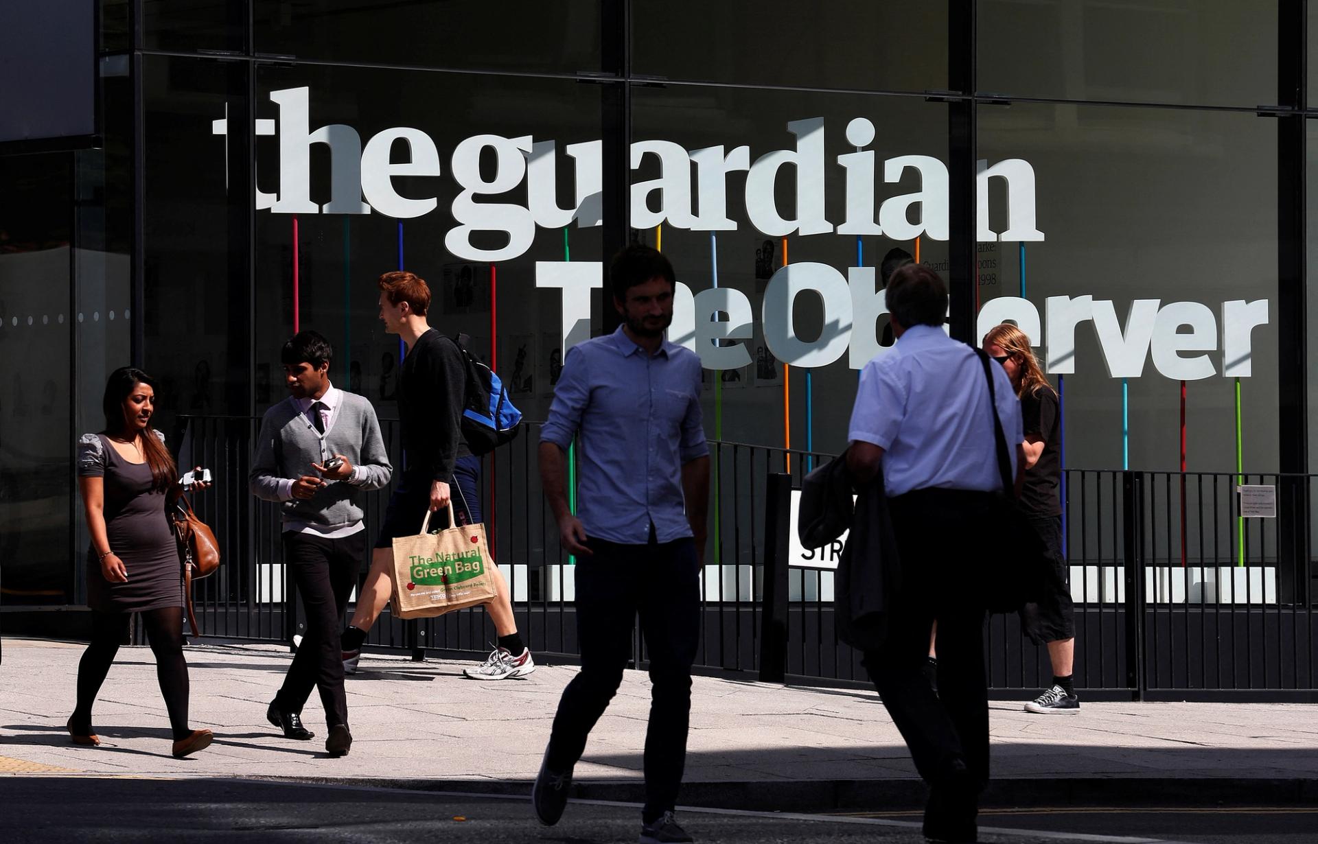 Pedestrians walk outside of the The Guardian and The Observer head quarters in London.