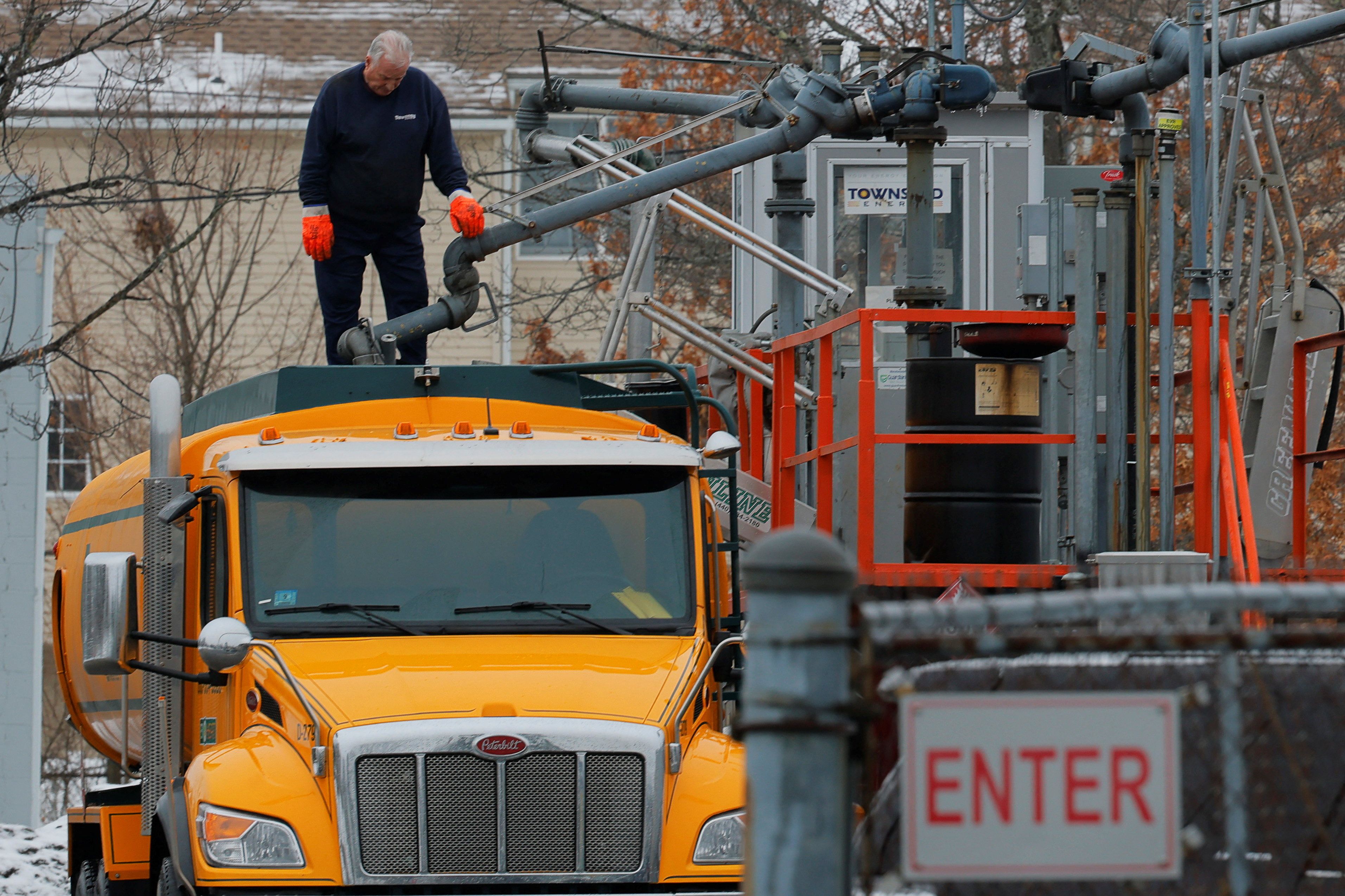 An oilman fills his home heating oil delivery truck