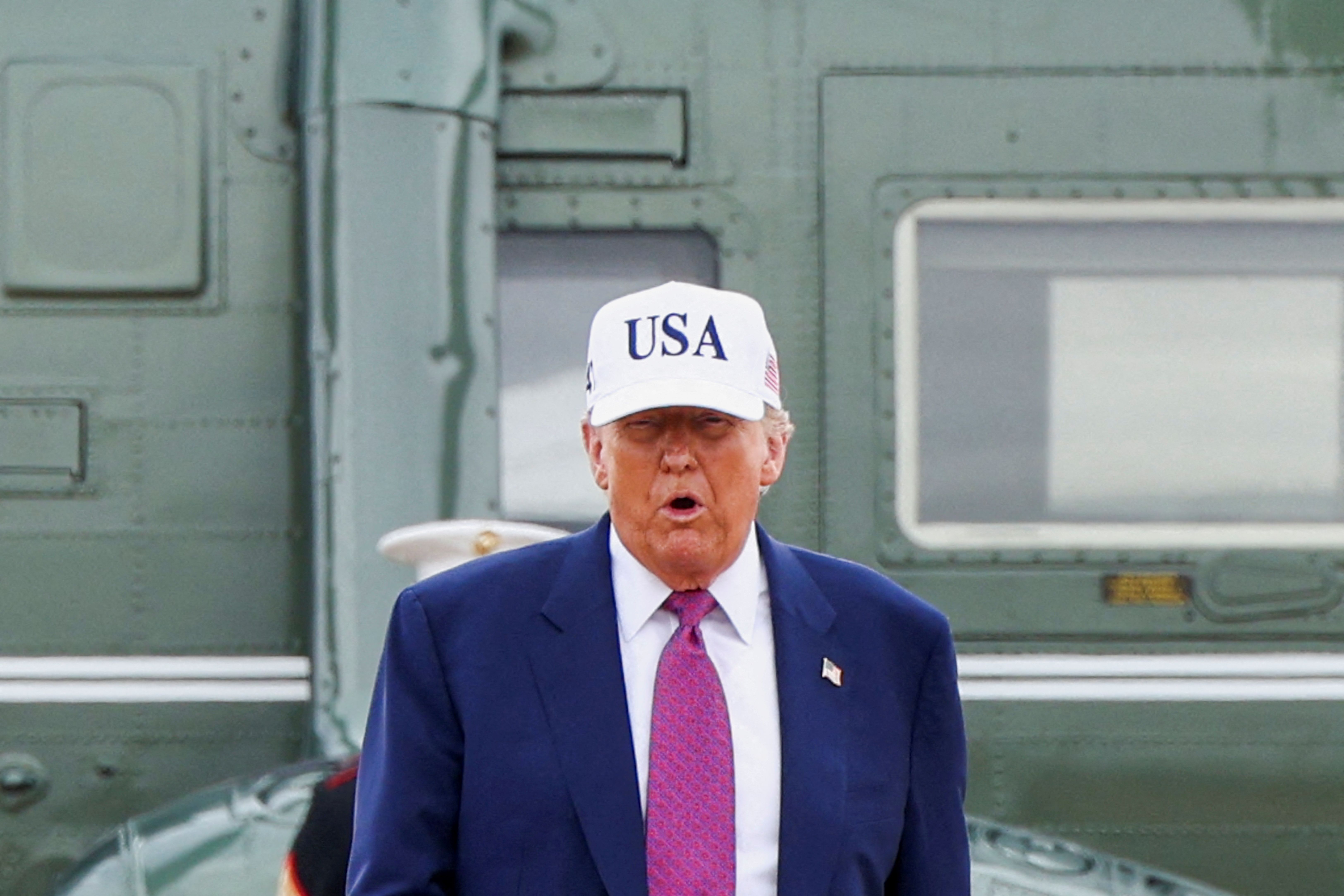 Donald Trump wearing a “USA” baseball cap.