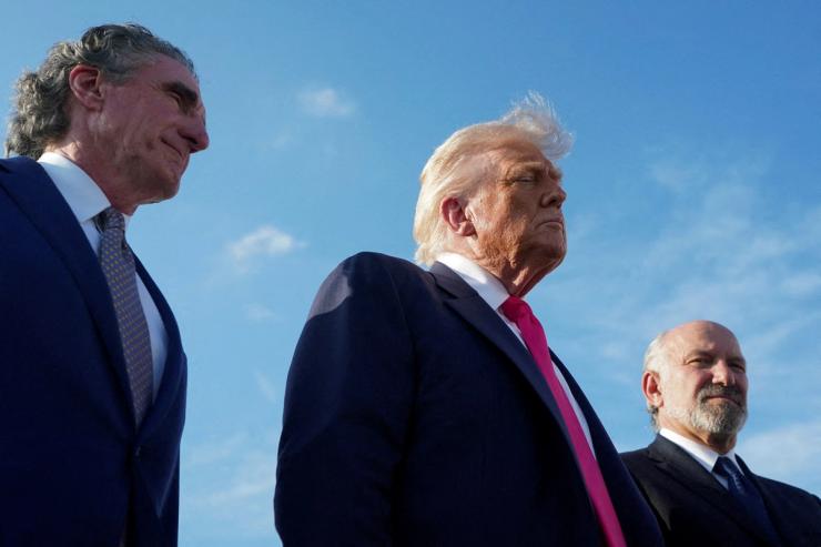 USPresident Donald Trump looks on as he speaks with the media, accompanied by US Secretary of the Interior Doug Burgum and US Secretary of Commerce Howard Lutnick