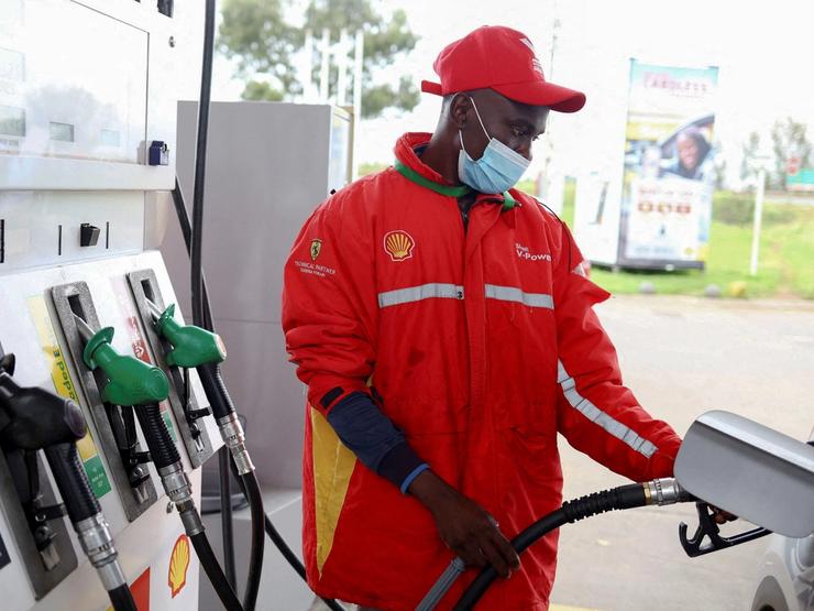 A worker fills a car at a fuel station in Johannesburg, South Africa, March 16, 2022.