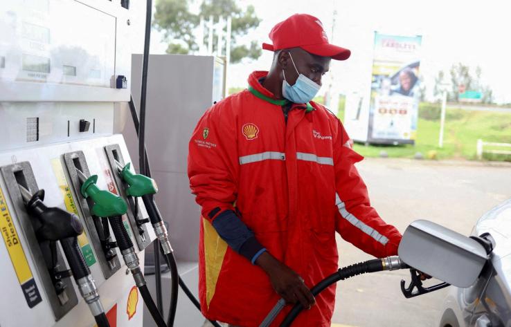 A worker fills a car at a fuel station in Johannesburg, South Africa, March 16, 2022.