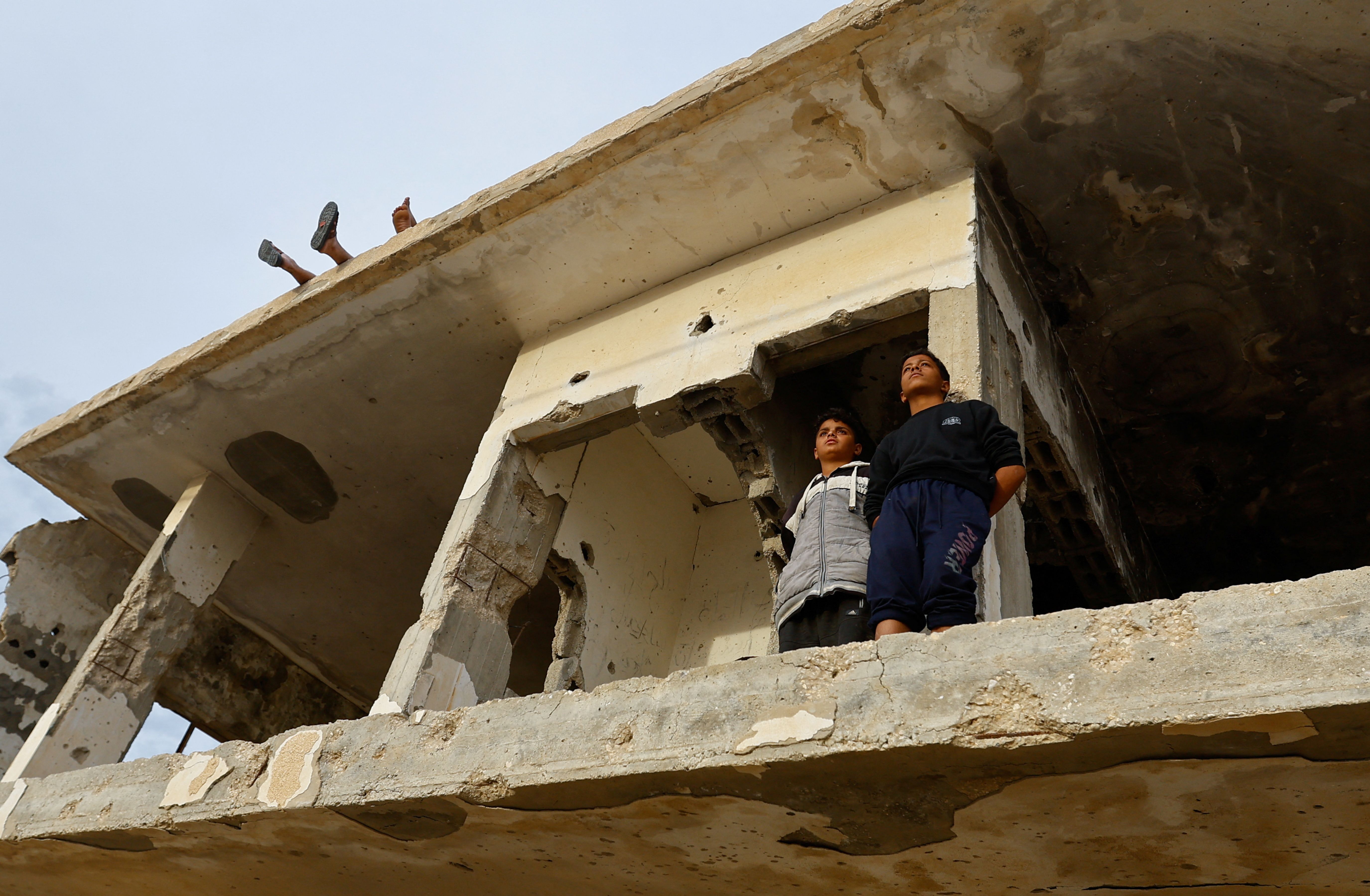 People gather near the Rafah border as Hamas militants are expected to release hostages on Nov. 25