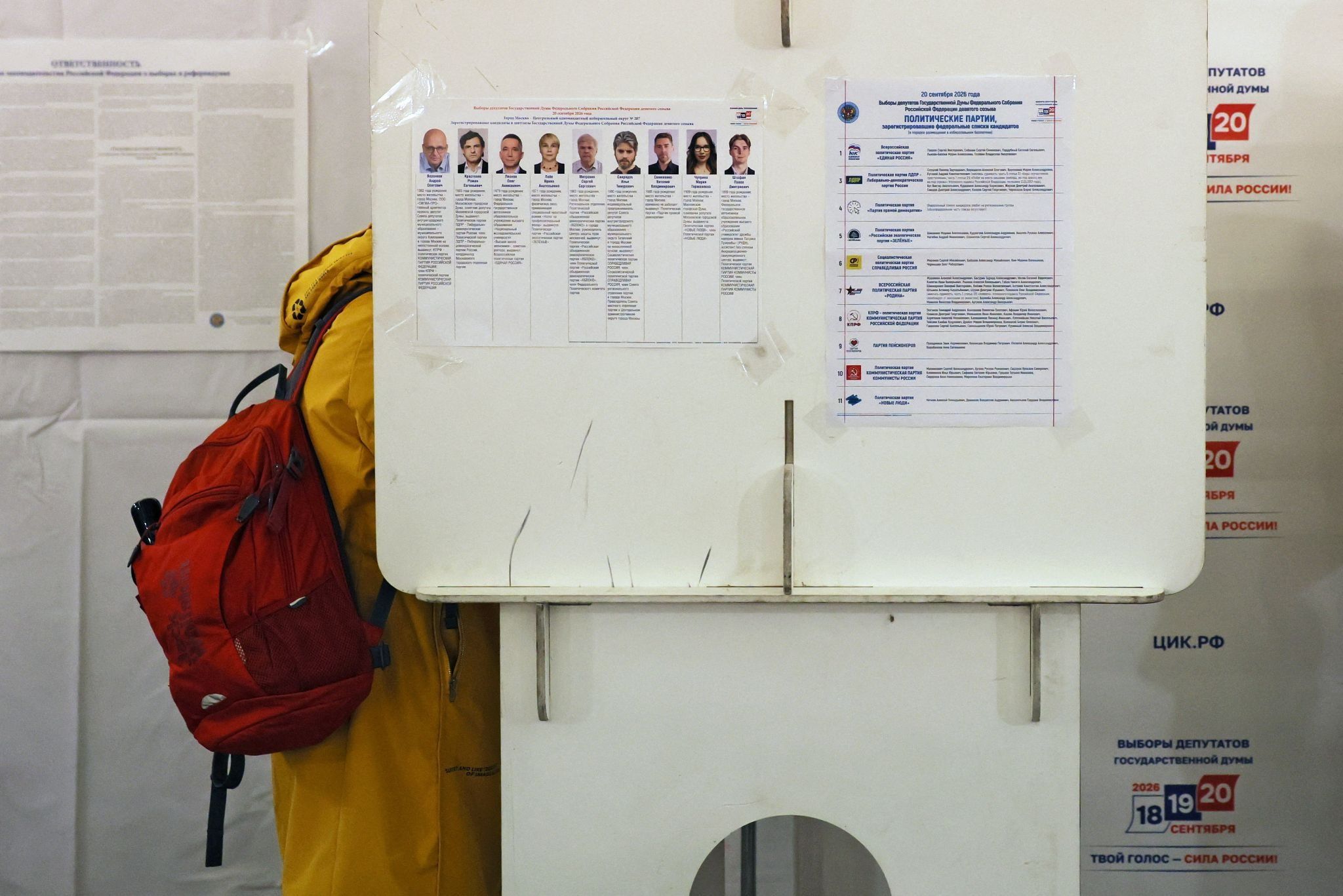 A person stands in voting booth during Russia’s parliamentary elections. 