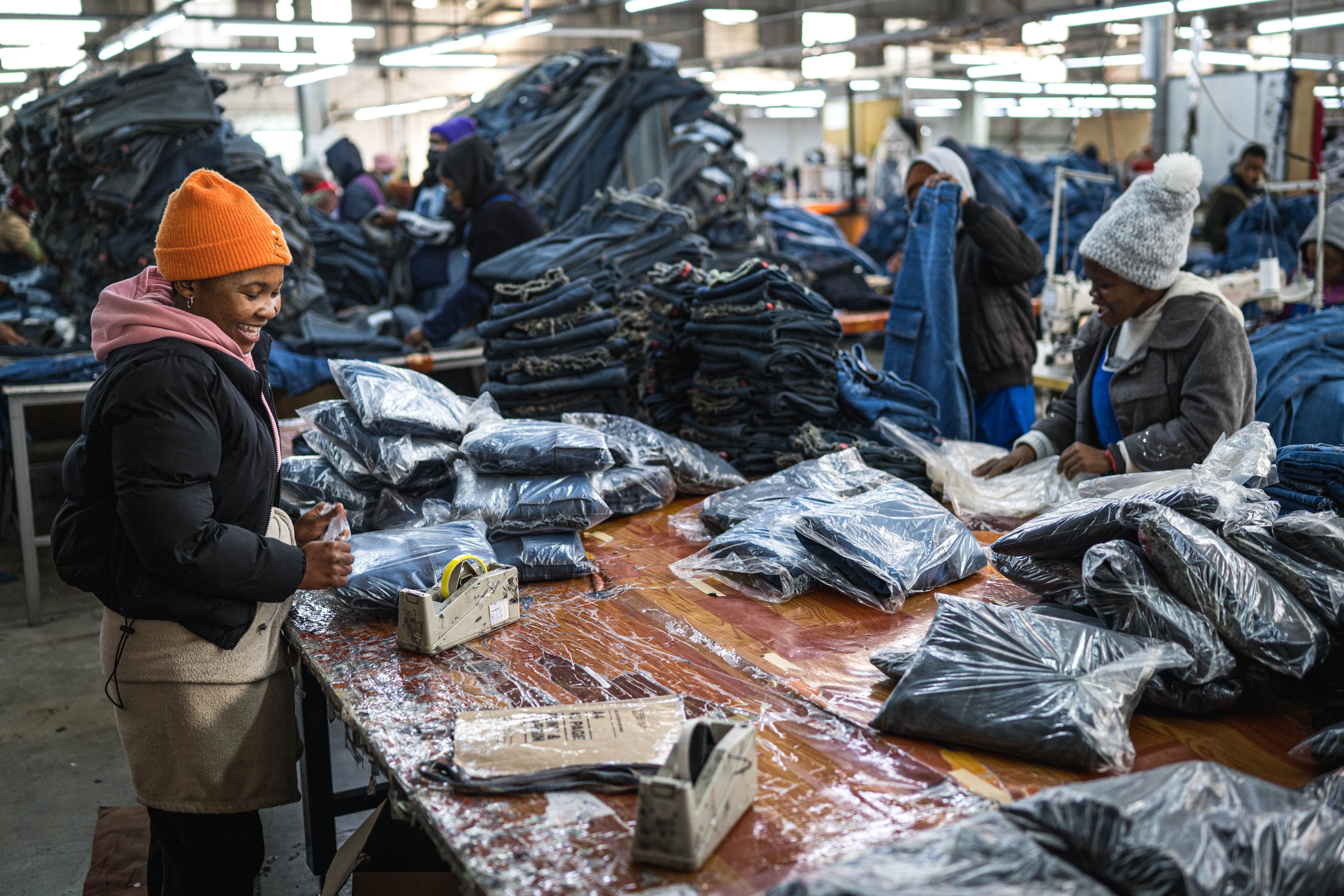 Workers arrange jeans at the Afri-Expo Textile Factory in Maseru, Lesotho.