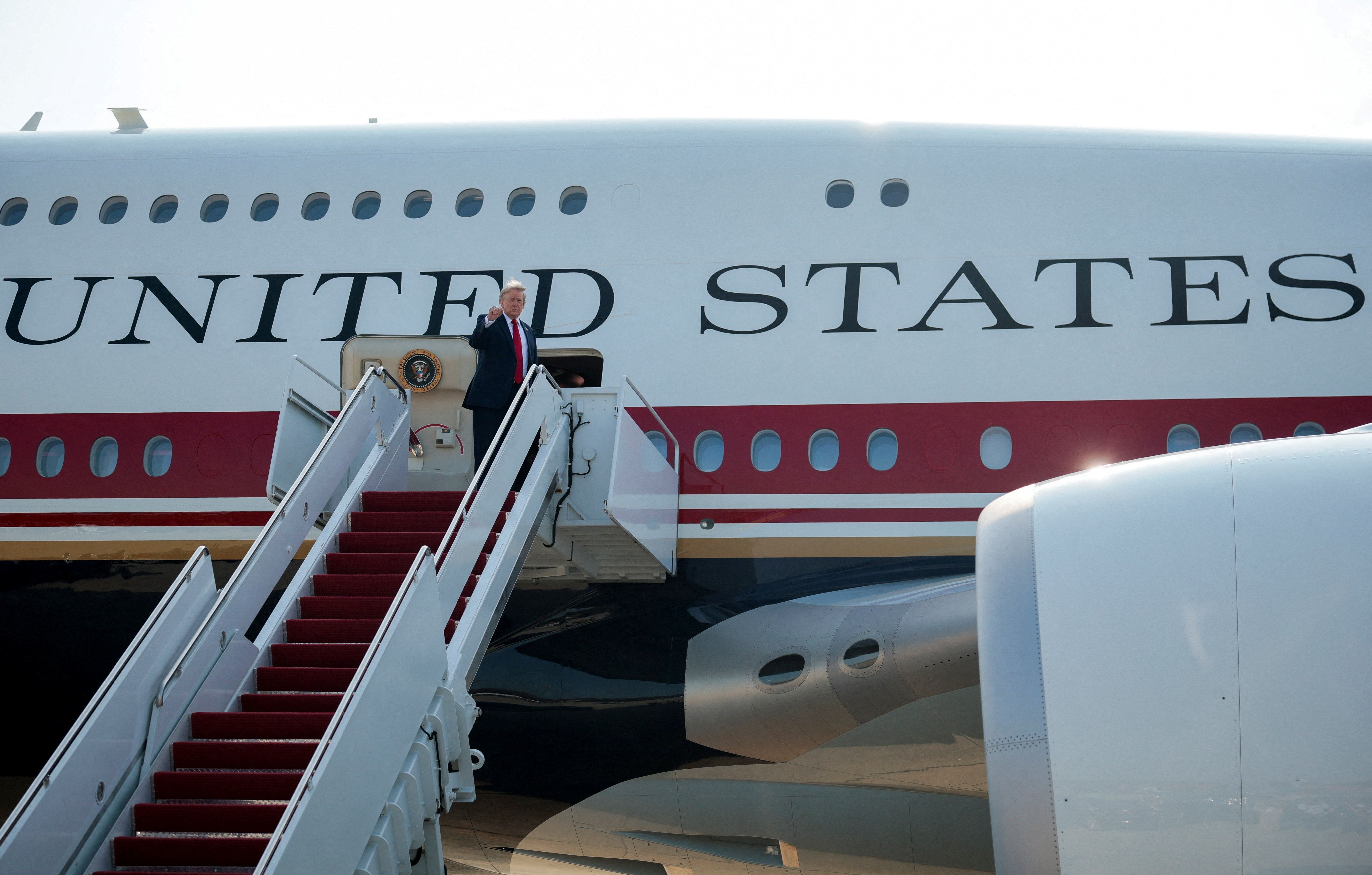 U.S. President Donald Trump gestures as he boards the new Air Force One, a plane gifted by the Qatari government.