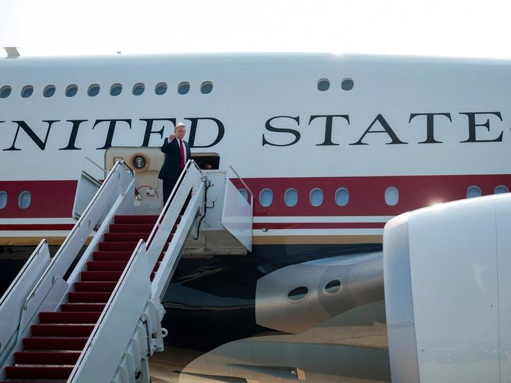 U.S. President Donald Trump gestures as he boards the new Air Force One, a plane gifted by the Qatari government.