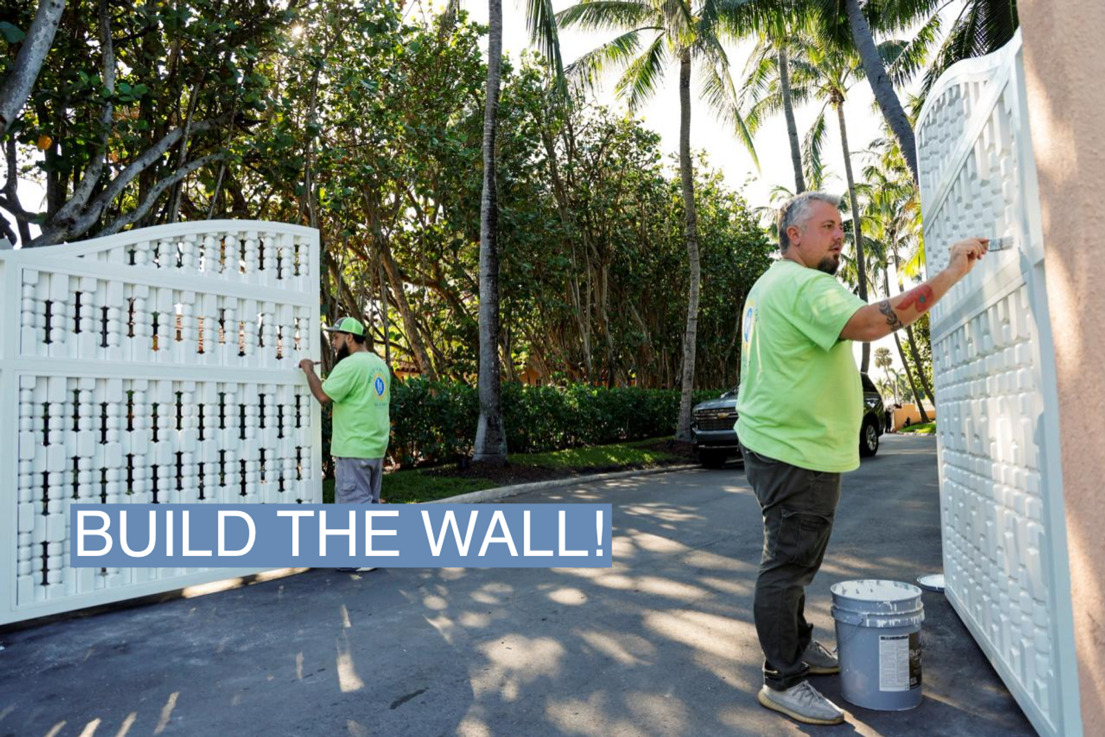 Workers paint the gates at Mar-a-Lago