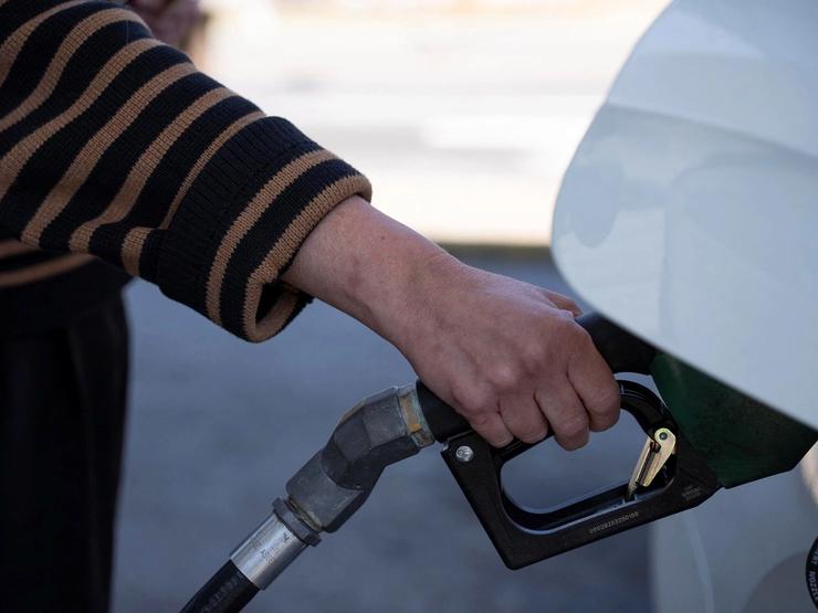 A person pumps gas