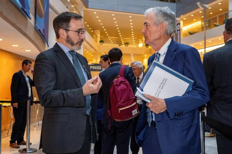 Chief Economist, International Monetary Fund Pierre-Olivier Gourinchas, left, speaks with Federal Reserve Chair Jerome Powell