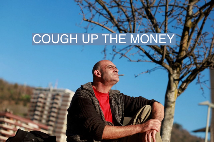 A man smoking a cigarette enjoys the sun during unseasonably warm temperatures in Bilbao.