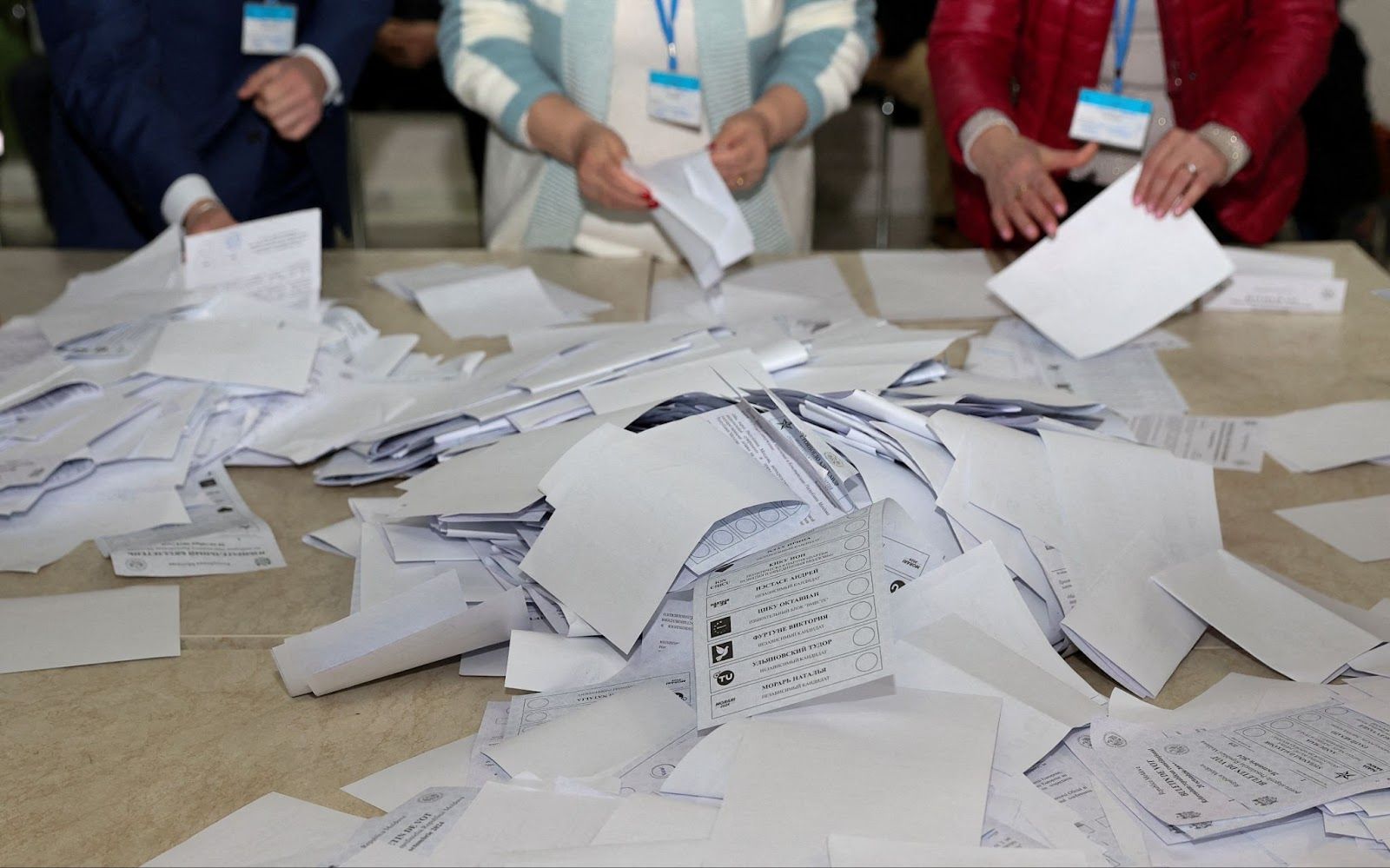 Members of an electoral commission count a pile of ballot papers after polling stations closed following Moldova’s presidential election and referendum on joining the EU
