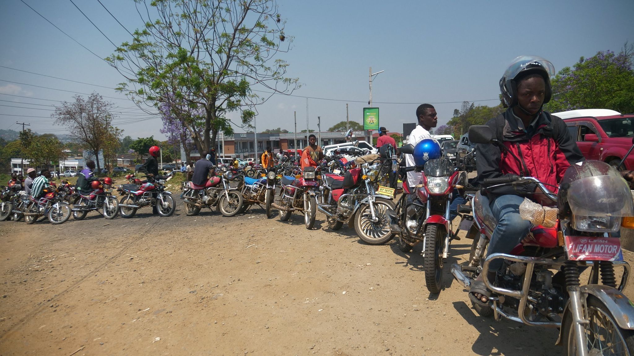 Motorbike riders line up to buy fuel in Blantyre, Malawi.