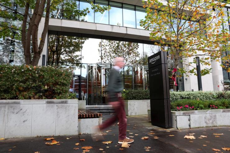 A pedestrian walks past Amazon Ireland corporate offices in Dublin.