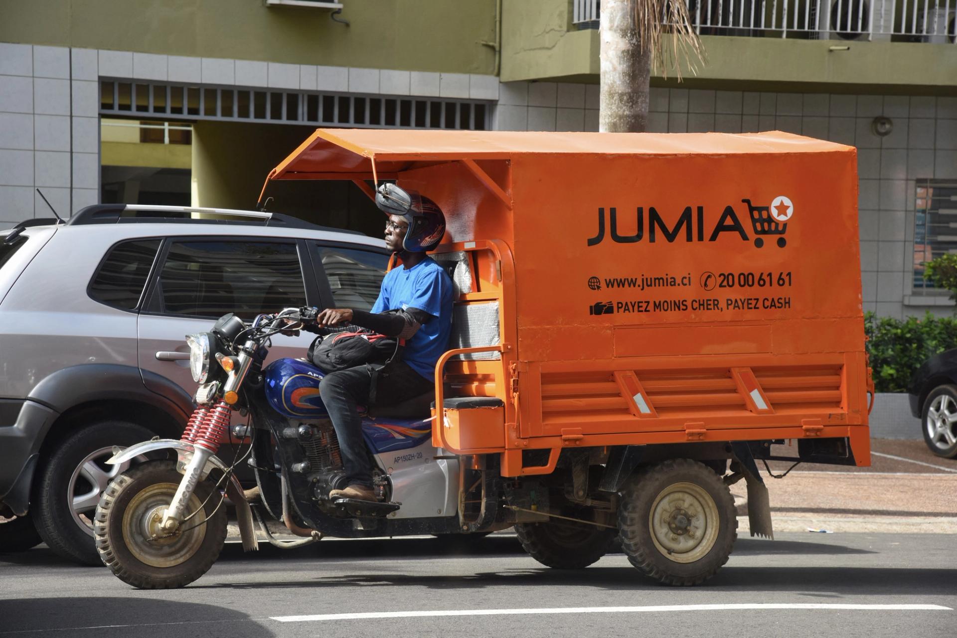 A delivery man drives a transporter with an advertisement for Nigeria’s e-commerce site Jumia in the Plateau district of Abidjan on April 24, 2019.