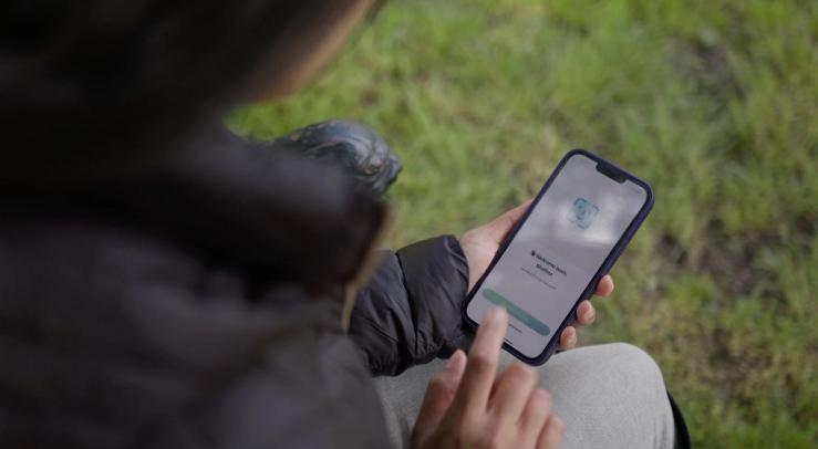 A woman using the LemFi app.