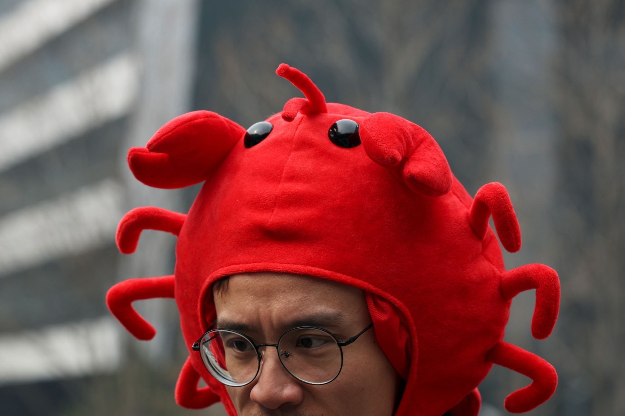 A staff member wears a lobster hat representing the logo of OpenClaw, an open-source AI agent, during a setup session outside the Baidu offices in Beijing, China 