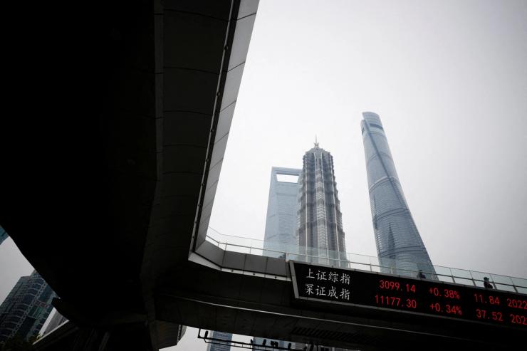 An electronic board shows Shanghai and Shenzhen stock indexes, at the Lujiazui financial district, following the coronavirus disease (COVID-19) outbreak, in Shanghai