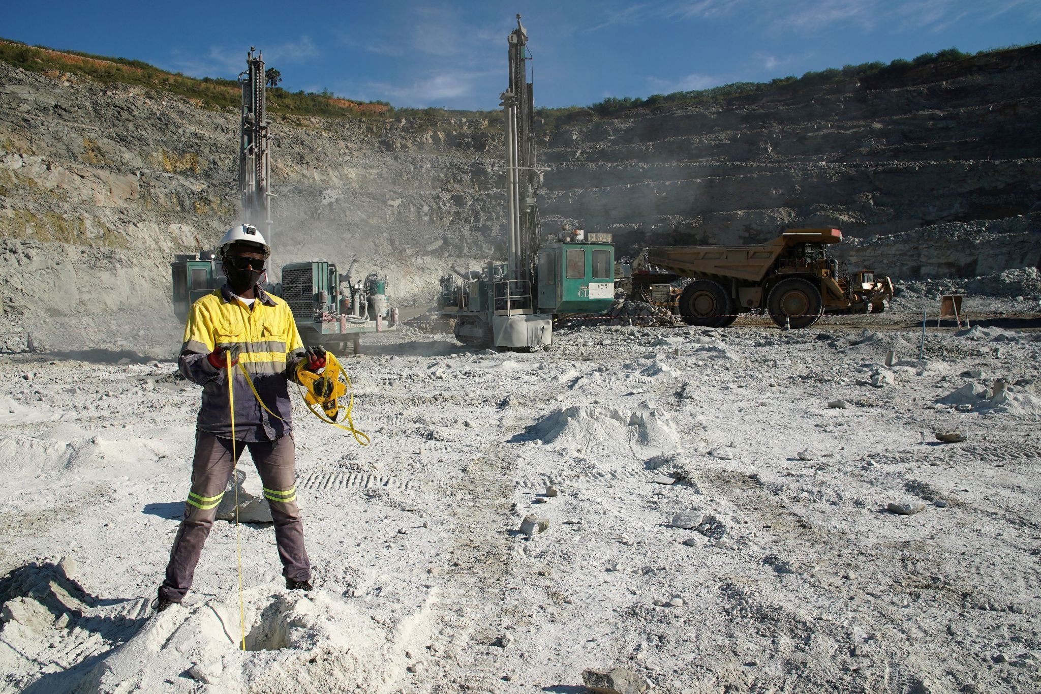 A miner measures the depth of blast holes at the Kibali gold mine Haut-Uele province, Democratic Republic of Congo.