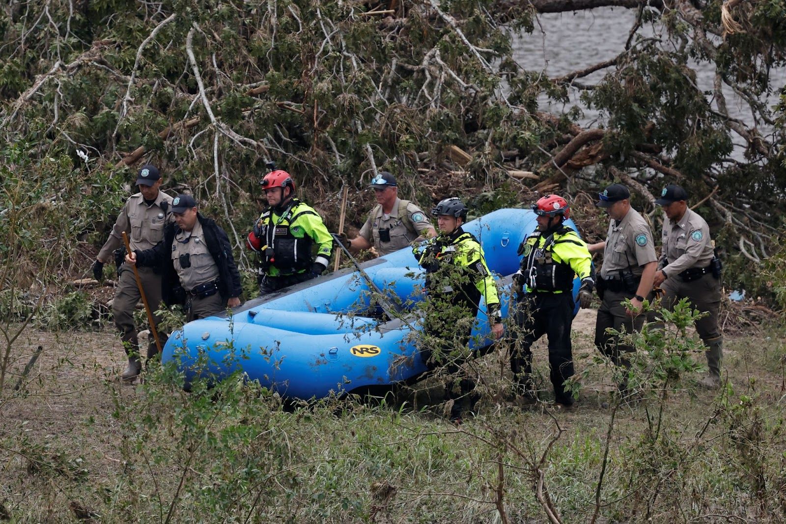 Texas emergency personnel carry an inflatable raft.