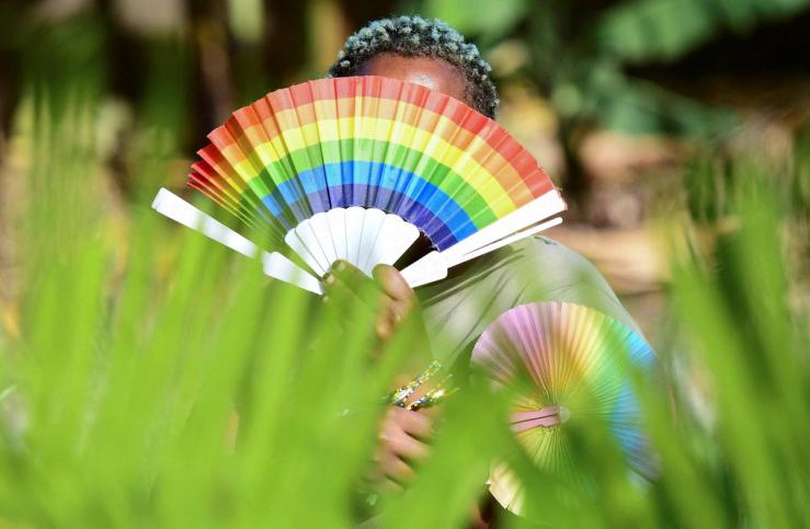 Quin Karala, 29, a member of the lesbian, gay, bisexual, transgender, intersex and queer (LGBTQ) community and a single mother of one poses for a picture with rainbow colours at the offices of Rella Women’s Empowerment Program, for LGBTQ rights advocacy, after a Reuters interview in Kulambiro suburb of Kampala, Uganda April 4, 2023. REUTERS/Abubaker Lubowa/File Photo