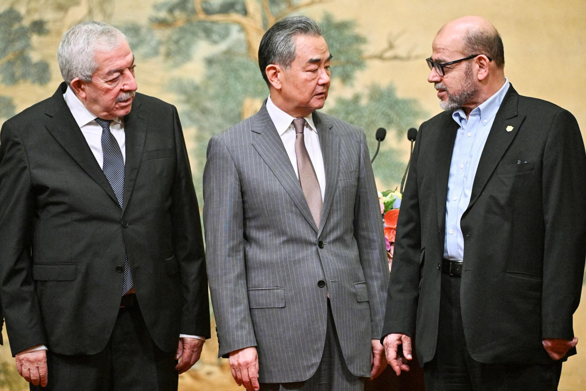 Mahmoud al-Aloul, Vice Chairman of the Central Committee of Palestinian organisation and political party Fatah, China's Foreign Minister Wang Yi, and Mussa Abu Marzuk, senior member of the Palestinian Islamist movement Hamas, attend an event at the Diaoyutai State Guesthouse in Beijing on July 23, 2024. PEDRO PARDO/Pool via REUTERS