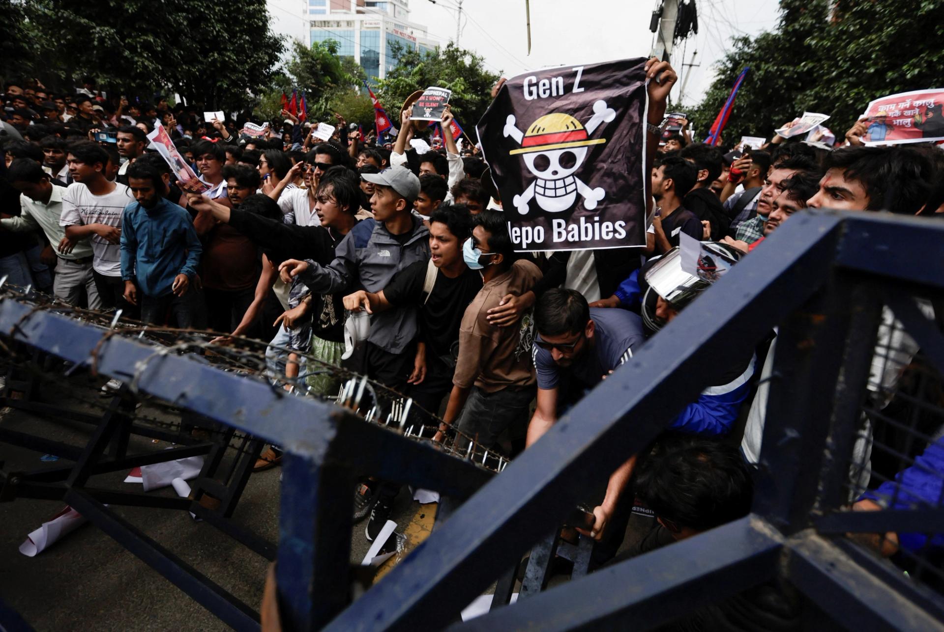 Demonstrators try to break through police barricades during a protest against corruption and the government’s decision to block several social media platforms, in Kathmandu.