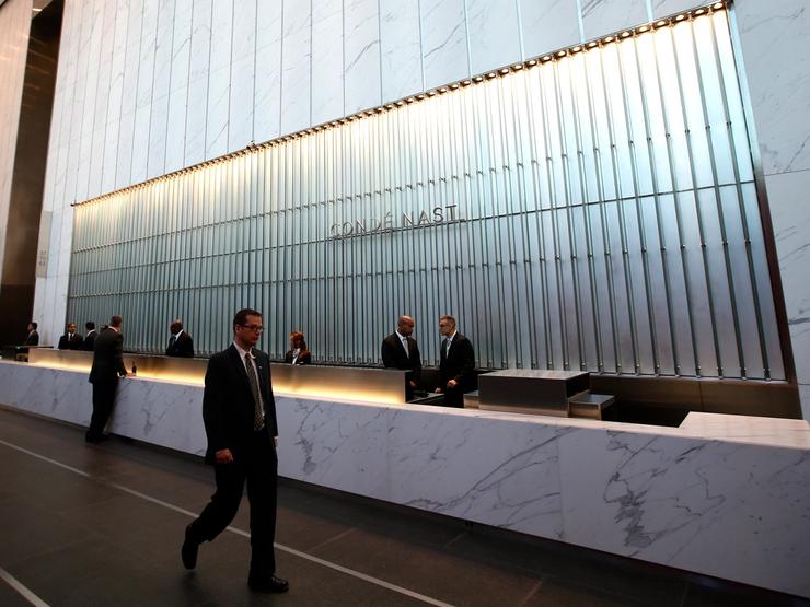 Conde Nast employees work in the lobby of the One World Trade Center tower in New York
