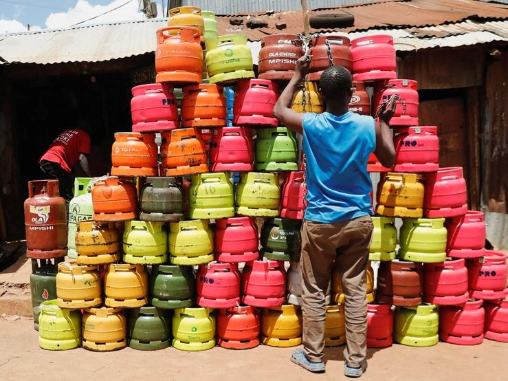 A man arranges cooking gas cylinders in Kibera settlement of Nairobi, Kenya.