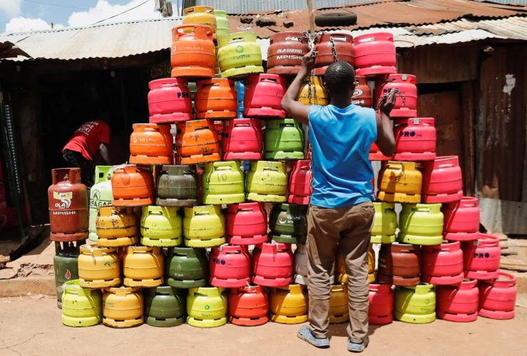 A man arranges cooking gas cylinders in Kibera settlement of Nairobi, Kenya.