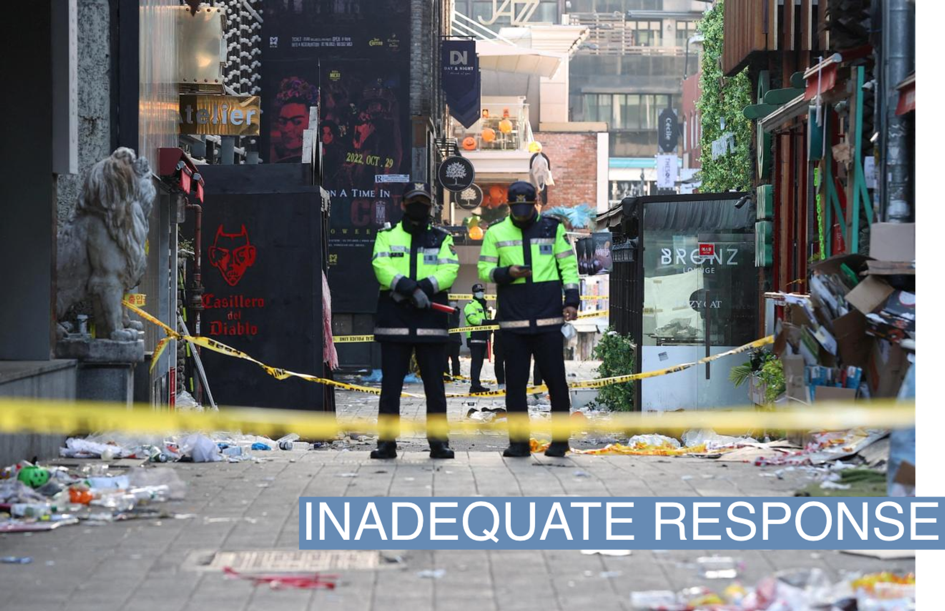 Policemen stand guard at the scene where a stampede during Halloween festivities killed and injured many people at the popular Itaewon district in Seoul, South Korea, October 30, 2022.