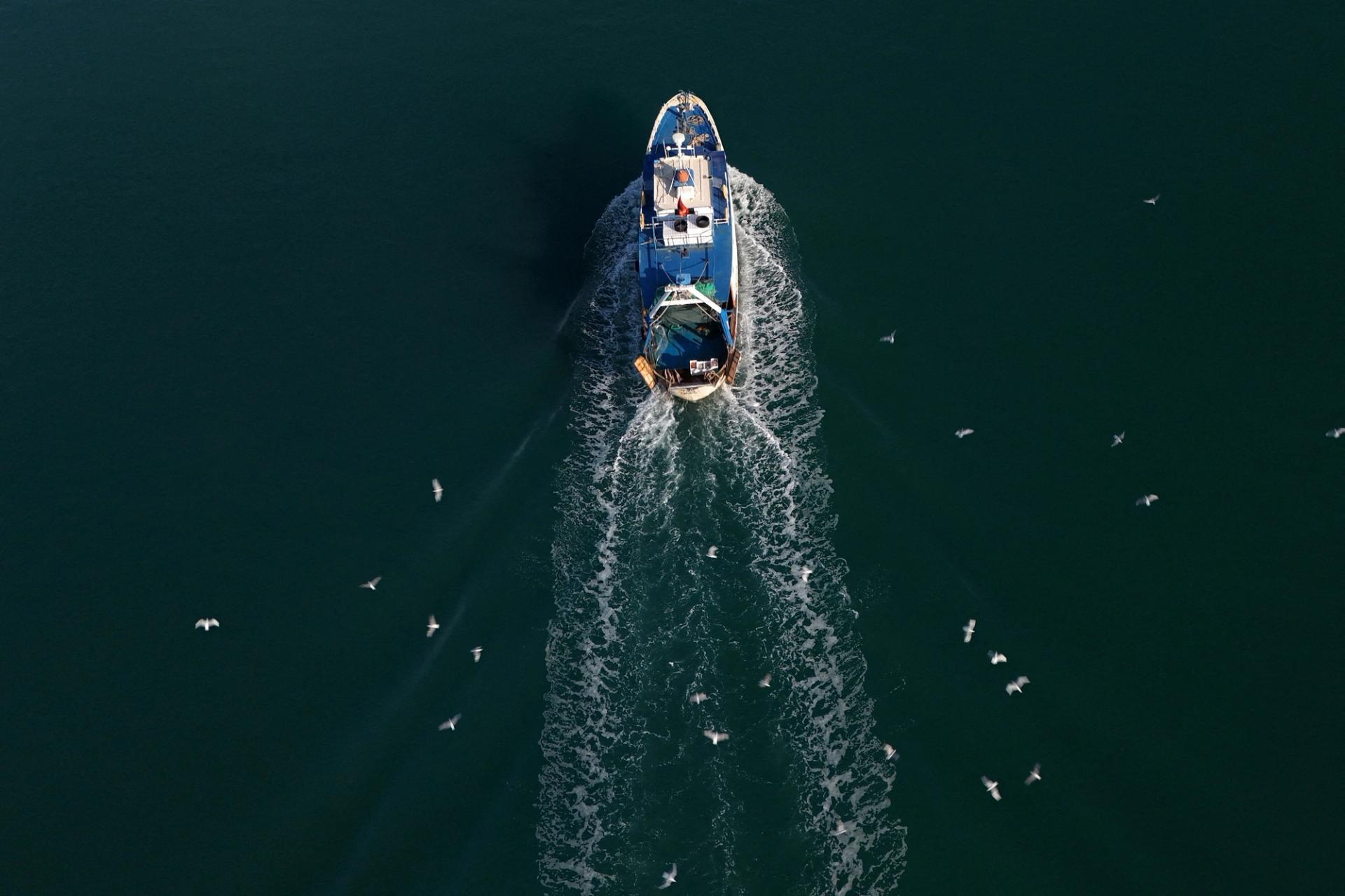 A boat near a reception camp for migrants brought from Italy to Albania.